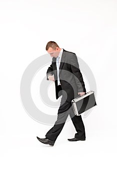 Hurrying to a businessman looking down at his watc