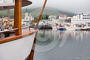 Husavik, Iceland - Fishing boats moored at harbour in subdued light