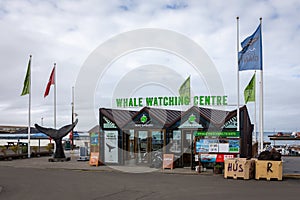 Whale Watching Centre building with ticket office and whale tail statue in Husavik Harbor, Iceland