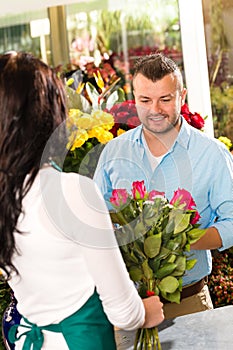 Husband buying roses bouquet romantic flower market