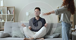 Husband doing meditation, express patience, not listening screams of wife