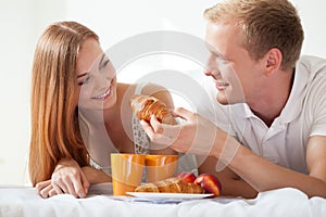 Husband feeding his wife