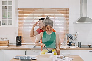 Husband feels worry behind his wife while she is cooking for him.