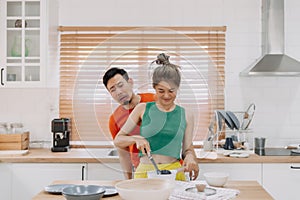 Husband feels worry behind his wife while she is cooking for him.