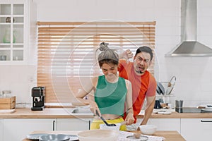 Husband feels worry behind his wife while she is cooking for him.