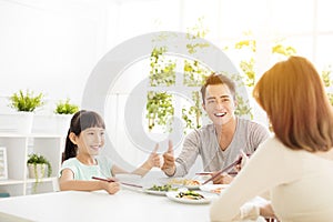 Husband gives his wife thumbs up for the delicious dinner