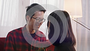 Husband giving red roses to his wife on Valentines day. Love and affection in young asian family