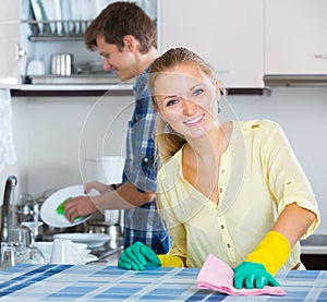 Husband helping housewife doing clean up