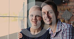 Husband hugging bald wife oncology disease patient feel optimistic