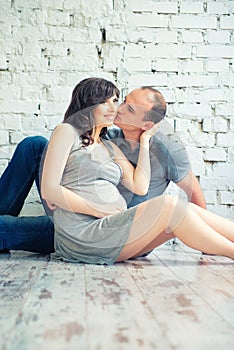 Husband kisses his pregnant wife