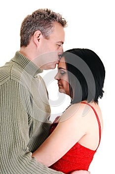 Husband kissing wife.