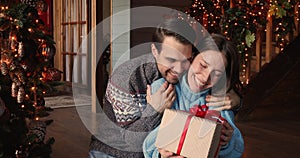 Husband makes Christmas surprise for wife congratulates her Merry Christmas