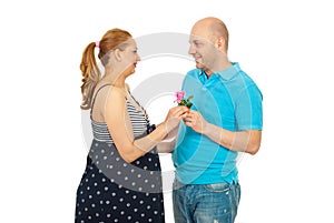 Husband offer pink rose to pregnant wife