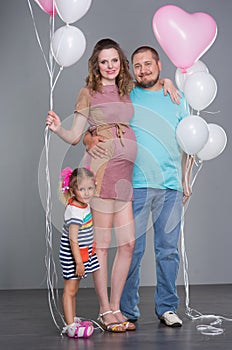 Husband and pregnant wife with a child
