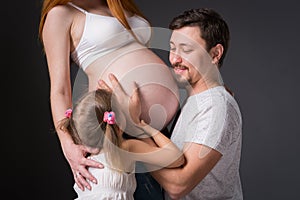 Husband and pregnant wife with a child