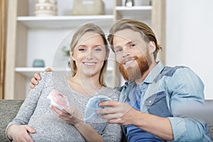 husband and pregnant woman looking at baby accessories