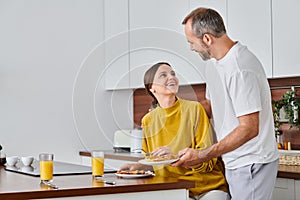 husband serving delicious breakfast near excited