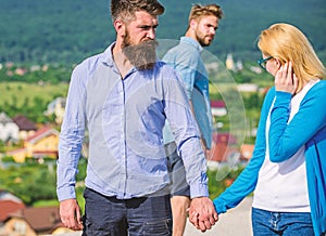 Husband strictly watching his wife looking at another guy while walk. Jealous concept. Man with beard jealous aggressive