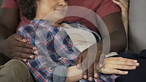 Husband tenderly touching tummy of his pregnant wife, happy family, expectation