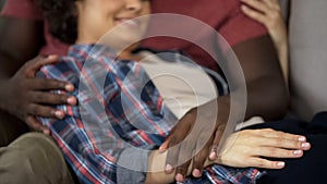 Husband tenderly touching tummy of his pregnant wife, happy family, expectation