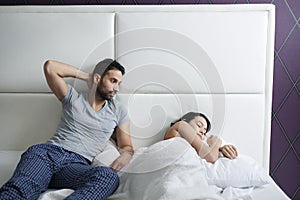 Man Trying Sexual Approach With Woman In Home Bed photo