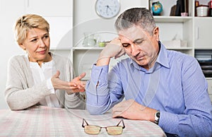 Husband and wife arguing with each other and try to resolve family conflict at table