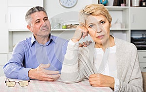 Husband and wife arguing with each other and try to resolve family conflict at table