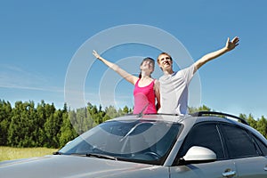 Husband, wife arrange hands in hatch of car photo