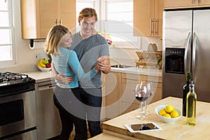 Husband and wife dance keeping the romance and playful relationship strong on a home date