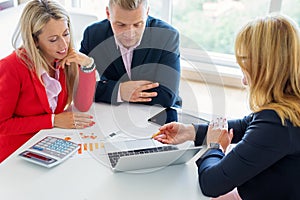 Husband and wife discussing investment plans with financial advisor