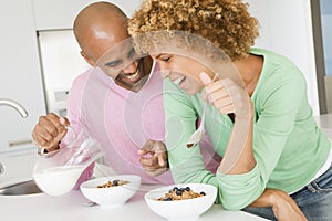 Husband And Wife Eating Breakfast Together