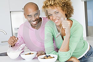 Husband And Wife Eating Breakfast Together