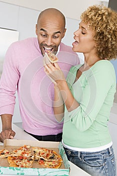 Husband And Wife Eating Pizza