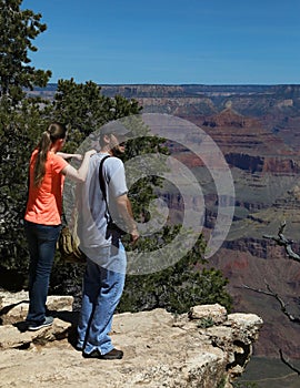 Husband & Wife Enjoying The Colors Of The Grand Canyon