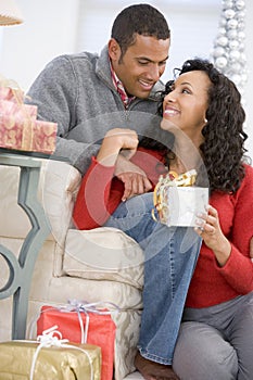 Husband And Wife Exchanging Christmas Gifts