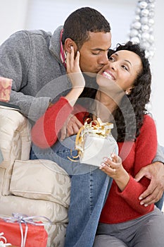 Husband And Wife Exchanging Christmas Gifts