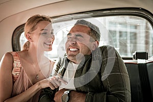 Husband and wife having fun tickling in the car.