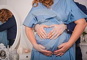 Husband and wife holding the pregnant belly