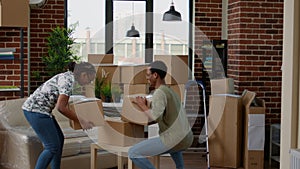 Husband and wife moving in new home with carton boxes