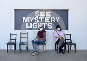 Husband and wife at a photography spot in Marfa, Texas referring to the famous Marfa mystery lights. photo