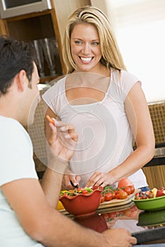 Husband And Wife Preparing Dinner