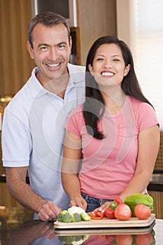 Husband And Wife Preparing Meal