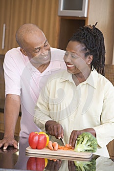 Husband And Wife Preparing A Meal Together