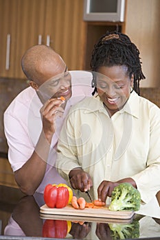 Husband And Wife Preparing A Meal Together