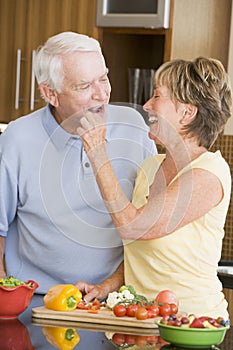 Husband And Wife Preparing Vegetables