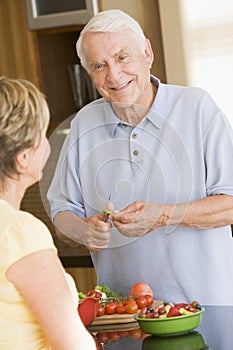 Husband And Wife Preparing Vegetables