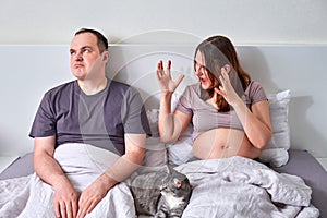 Husband and wife quarrel, pregnant woman yells at man in home bed