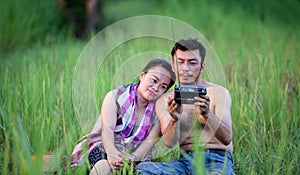 Husband and wife Thai farmers in the rice field