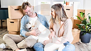 Husband and wife and their dog moving in new home - Young couple just moved into new apartment