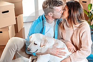 Husband and wife and their dog moving in new home - Young couple just moved into new apartment